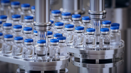3d render, conveyor with the glass jars, modern pharmaceutical factory. Closeup of ampules are being filled with vaccine and closed with blue caps. Medical wallpaper - 652070562