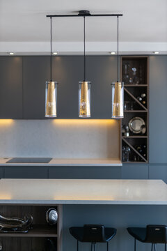 Decorative lamps hanging over kitchen island table