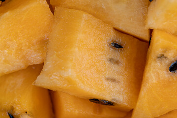 ripe orange watermelon with black pits watermelon close-up