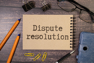 Dispute resolution. sticker text on black notepad