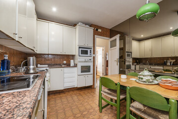 Kitchen furnished with white furniture,