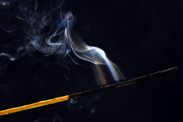 smoking match on a black background. Heat and light from fire flame