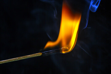 Fire and smoke. Burning and smoking match on a black background. Heat and light from fire flame