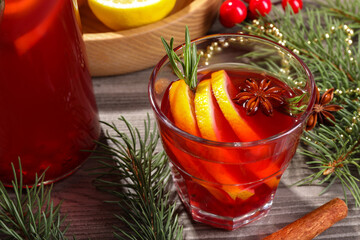 Aromatic punch drink and Christmas decor on wooden table
