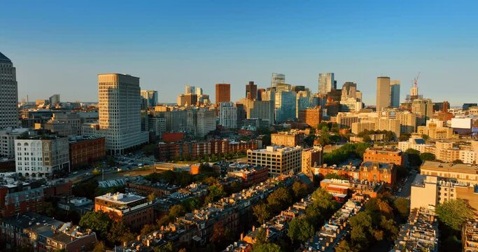 Amazing panorama of Boston in the rays of setting sun. Drone footage above the low-rise architecture of the city.