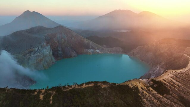 aerial view of Ijen volcano in East Jawa, Indonesia at sunrise, drone shot of volcanic caldera with sulphur gases at dawn, tourism in Ijen volcano national park in Jawa