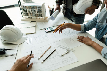 Group of engineer is discussion and brainstorming about blueprint of construction project in office