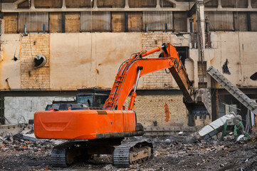 Hydraulic excavator works with garbage at demolition site