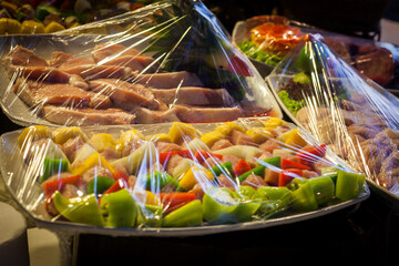 Decoration and raw foods that are wrapped with plastic wrap prepared for the wedding dinner party.