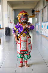 Fototapeta na wymiar Happy and smile Asian boy wearing Hanuman Khon. Hanuman is Thailand traditional dance. KHON HANUMAN RAMAYANA. masked Khon Hanuman in Literature Ramayana.