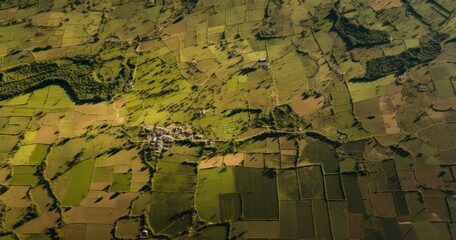 The perspective from a drone camera, showing patterns of fields and farmlands from above