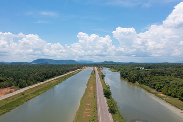 Aerial top view of a garden park with green mangrove forest trees, river, pond or lake. Nature landscape background, Thailand.