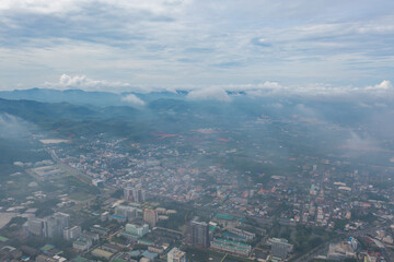 Aerial view of residential neighborhood roofs with fog mist in rainy season. Urban housing development from above. Top view. Real estate in Phuket, southern province city, Thailand.