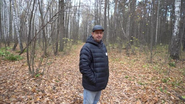 Man 50 years old walking in the autumn forest, says text