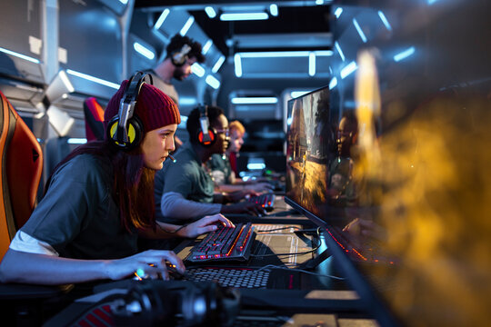 Diverse female esports team playing a video game and competing in an esports tournament
