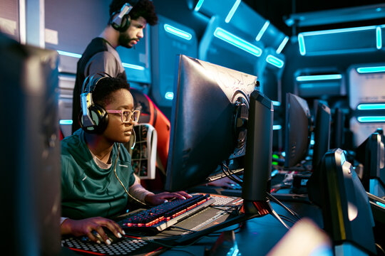 Diverse female esports team playing a video game and competing in an esports tournament