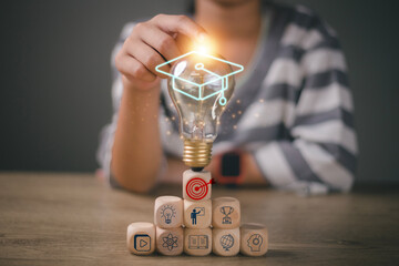 Hands-touching light bulb with graduation hat on wooden cubes stacked, Internet education course...