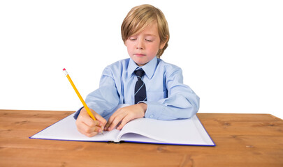 Digital png photo of smiling caucasian schoolboy writing on transparent background