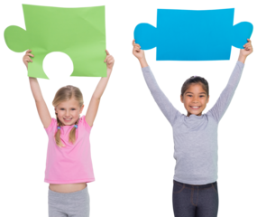 Digital png photo of diverse girls holing puzzle pieces with copy space on transparent background