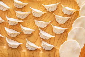 raw gyoza on the wooden background
