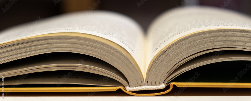 Aufkleber open book close up. one book is yellow. concept of reading and learning books.