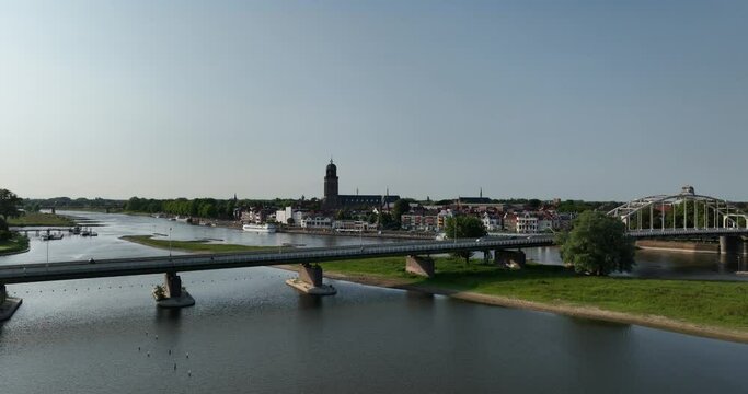 Aerial drone view of a rising aerial drone view of the skyline of Deventer, showing the iconic Wilhelminabrug and the Lebuinuskerk Ijssel river and the city skyline