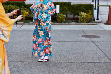 Back view of woman wearing yukata at temple
