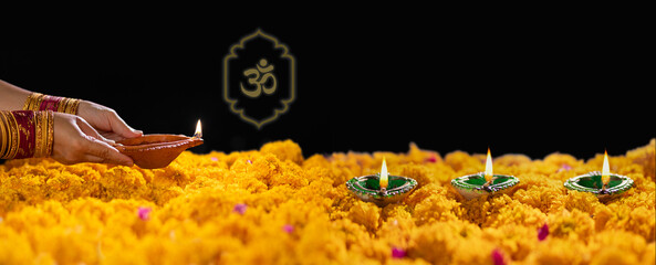 Happy Diwali - Diya lamps lit during diwali celebration. Translate Aum alphabet is a symbol of...