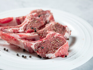Raw lamb ribs seasoned with various spices
