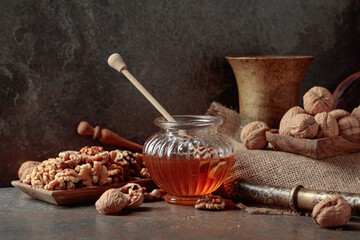 Honey and walnuts on a kitchen table.
