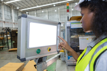 woman engineer using computer blank white screen controlling machine at workshop. female control automated machine process programming cnc machine at industry manufacturing. Computer Mockup.