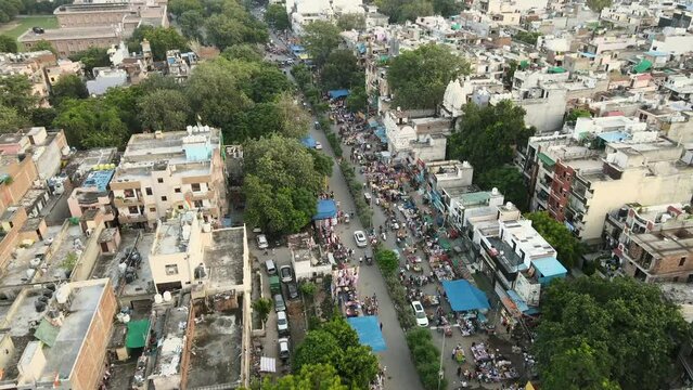 4K Aerial Shots of a Local market in New Delhi Residential Suburbs on a beautiful day gliding over Rooftops, streets, parks and markets in India