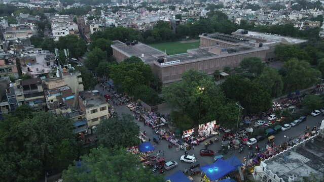 4K Aerial Shots of a busy road intersection in New Delhi Residential Suburbs on a beautiful day gliding over Rooftops, streets, parks and markets in India