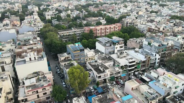 4K Aerial Shots of New Delhi Residential Suburbs on a beautiful day gliding over Rooftops, streets, parks and markets in India