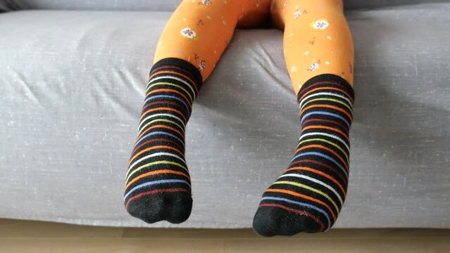 a colorful soft socks on child feet .