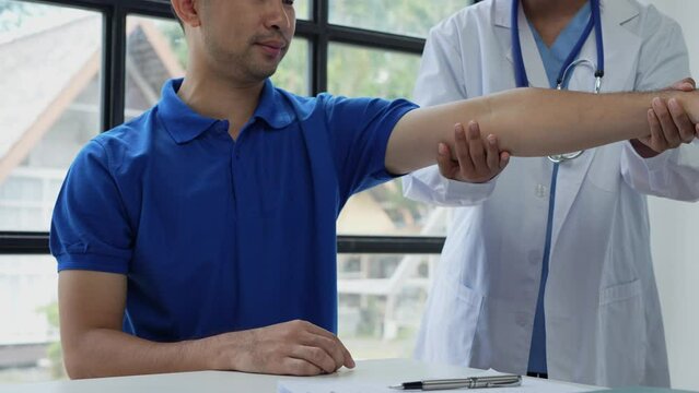 The doctor counsels the patient about pain in the muscles of the arms and elbows. office syndrome problem physical therapy diagnostic concept