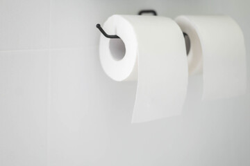 Black holder for white toilet paper. Two rolls. White background