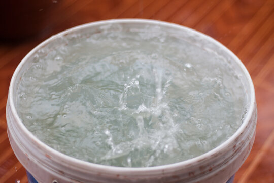 Rain is falling in a bucket full of water.Rainwater harvesting.Rainy season is coming.