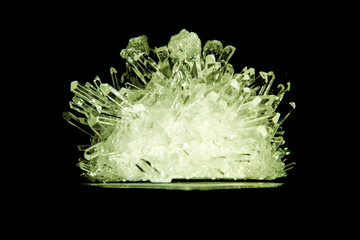 Shiny green sharp emerald crystal highlighted and isolated on black background. Geology and mineralogy objects. Precious formations