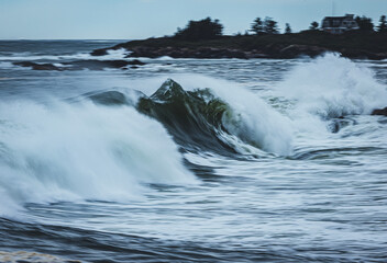 large atlantic ocean wave breaks along the Maine coast during storm