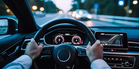 Deurstickers hands on the steering wheel in modern interior © xartproduction