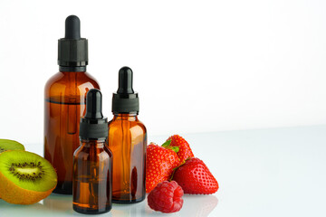 Electronic cigarette liquids with berry and kiwi flavor on white background