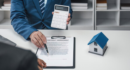 House model with agent and customer discussing for contract to buy, get insurance or loan real estate or property...