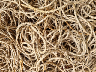 Tangled coarse linen ropes. Texture for the background. Selective focus