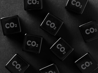 Environmental pollution and carbon emission concept. CO2 carbon dioxide symbol on black cubes.