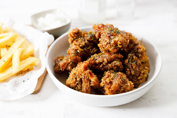 Fried chicken with soy sauce in Korean style with pickled radish.