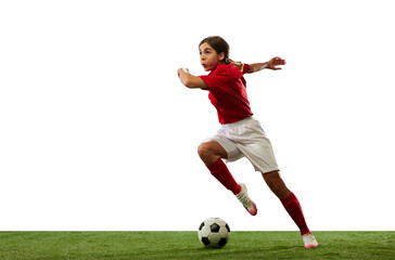 Motivated young girl, football player in motion, running with ball isolated over white background....