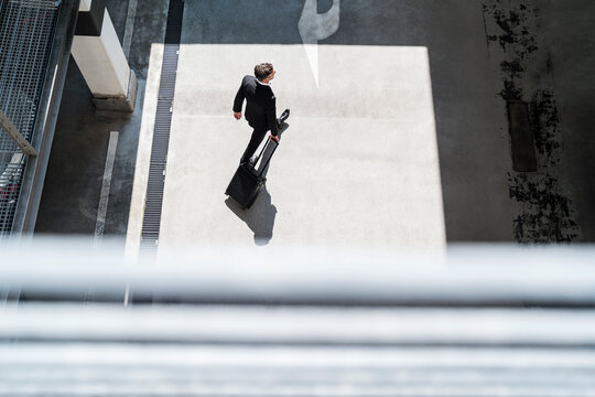 Top view of businessman with baggage on the go