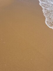wet sand at the sea coast, natural sea sand texture