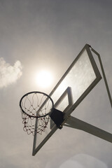 Outdoor basketball hoop against the blue sky.Low angle view.